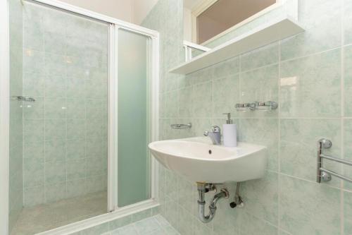 a bathroom with a sink and a shower at Apartments Placa Dubrovnik in Dubrovnik