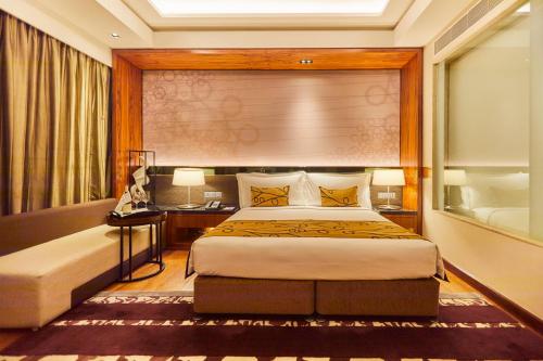 a hotel room with a bed and a window at Crowne Plaza New Delhi Rohini by IHG in New Delhi