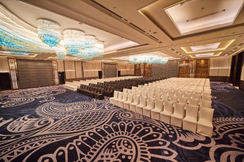 a banquet hall with rows of white chairs and chandeliers at Crowne Plaza New Delhi Rohini by IHG in New Delhi