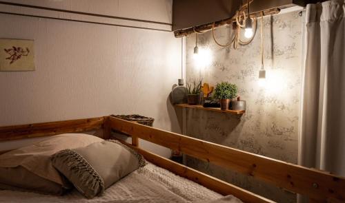 a bedroom with a bed and a chandelier at Abacard Home Chambre d'Hôtes adult only in Roquemaure