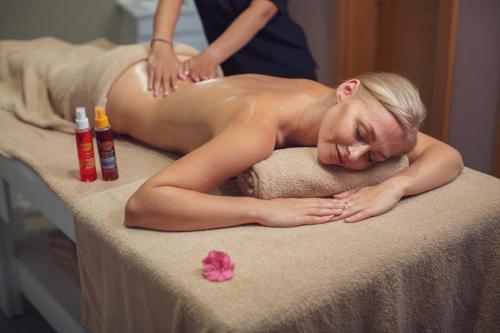 a woman getting a massage at a massage table at Orka Cove Hotel Penthouse & Suites Adults Only in Fethiye