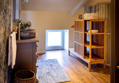 a room with a kitchen with a wooden floor at Abacard Home Chambre d'Hôtes adult only in Roquemaure