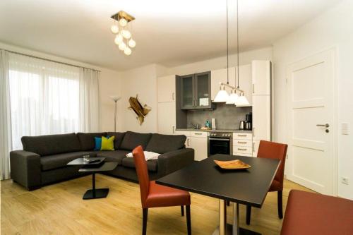 a living room with a couch and a table at Ostseedomizil La Mer in Börgerende-Rethwisch