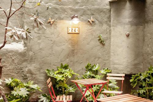 a clock on the side of a wall with plants at Luxury Suites Palace by Rikas Hotels in Antwerp