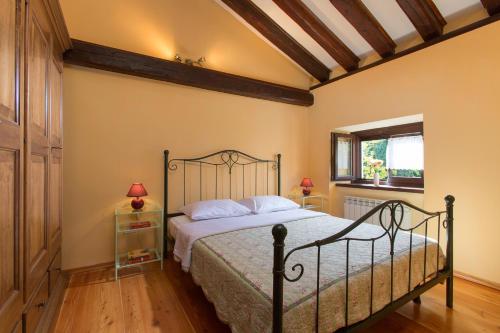 a bedroom with a bed and a window at Villa Momiano with Private pool in Momjan