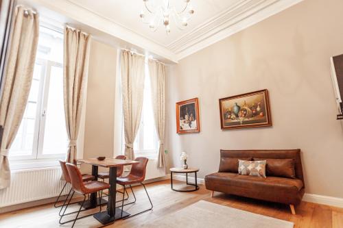 a living room with a couch and a table at Luxury Suites Palace by Rikas Hotels in Antwerp