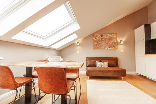a dining room with a skylight and a table and chairs at Luxury Suites Palace in Antwerp