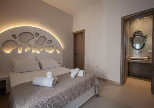 a bedroom with a large bed with towels on it at DAFNES VILLA 1 Private Pool in Perivolos
