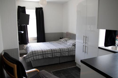 a small bedroom with a bed and a window at Bursar Street 19 in Cleethorpes