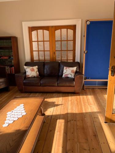 a living room with a couch and a wooden floor at Kings Lodge Hotel in Great Yarmouth
