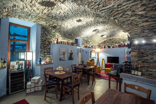 um restaurante com mesas e cadeiras e uma parede de pedra em Rifugio Lilla em La Thuile