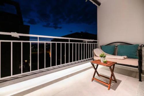 a balcony with a couch and a table at Kailani Luxury Central 3 Bedroom, 3 Bathroom Apartment With a Sunny Balcony in Zadar