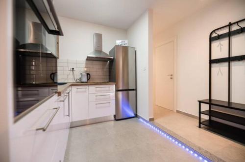 a kitchen with a stainless steel refrigerator in it at Kailani Luxury Central 3 Bedroom, 3 Bathroom Apartment With a Sunny Balcony in Zadar