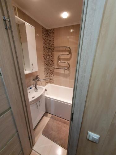 a bathroom with a tub and a sink and a toilet at Kreenholm apartments in Narva