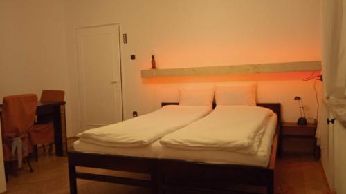 a bed with white sheets and pillows in a room at Królówka in Maków Podhalański