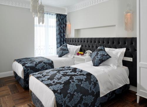a bed room with two beds and two pillows at Nexthouse Pera Hotel in Istanbul