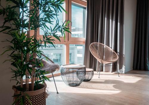 a living room with two chairs and a large window at Smartflats Design - L42 in Brussels