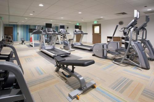 a gym with several treadmills and cardio machines at Holiday Inn Indianapolis - Airport Area N by IHG in Indianapolis