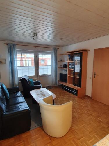 sala de estar con sofá y mesa en Eden´s Ferienwohnungen, en Neuharlingersiel