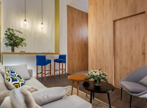 a living room with a couch and a table at Casa Sevilla 1920 Suites by Época in Seville