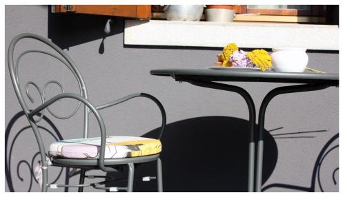 a table and chair with a plate of food on it at A Cjase di Lise in Gemona del Friuli