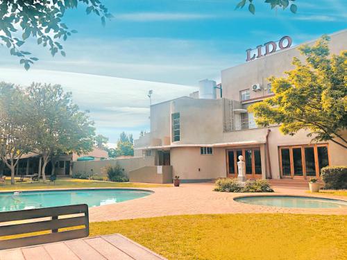 a building with a swimming pool in front of it at Lido Hotel in Johannesburg