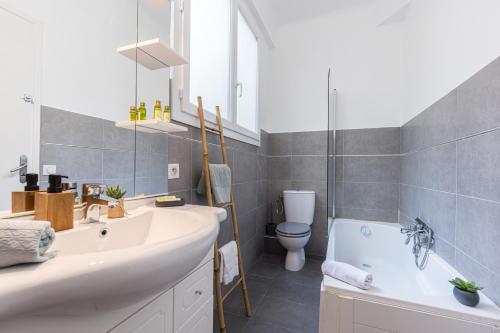 Un baño con lavabo, bañera e inodoro. en FEEL HOME - DE GAULLE - Villefranche-sur-Mer, en Villefranche-sur-Mer