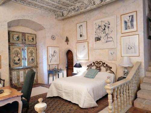 a bedroom with a white bed and a staircase at château de Mauriac in Senouillac