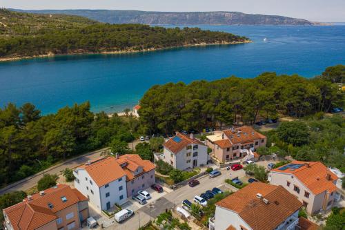 an aerial view of a town next to a lake at Room Elelina in Cres