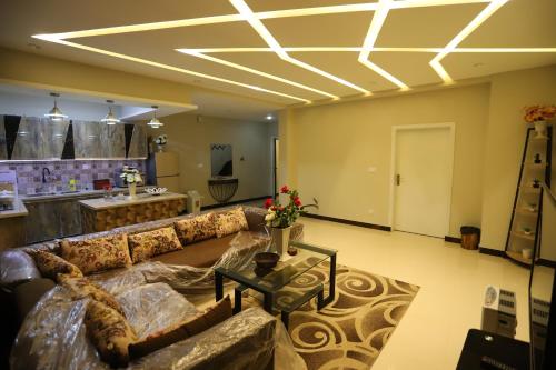 a living room with a couch and a table at Aloche Apartments in Murree