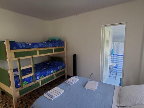 a bedroom with two bunk beds and a blue bed at El Piropo in La Vega