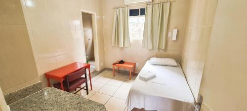 Ένα ή περισσότερα κρεβάτια σε δωμάτιο στο Hotel Metrópole