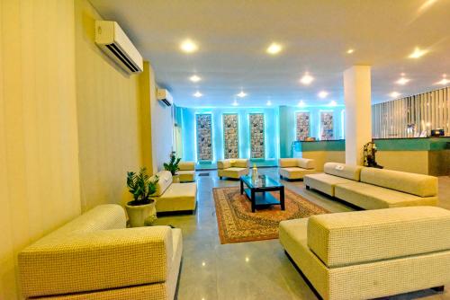 a living room filled with furniture and a large window at Randiya Sea View Hotel in Mirissa