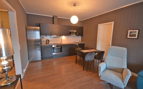 a kitchen with a table and chairs in a room at Trysil-Knut Hotel in Trysil