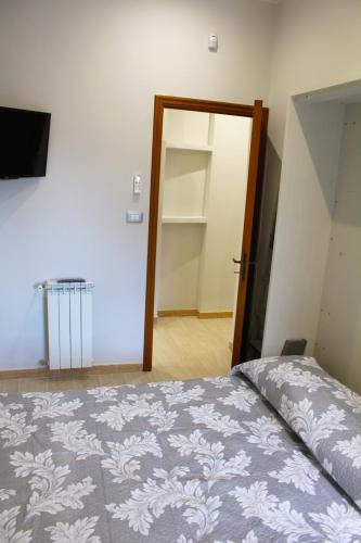 a bedroom with a bed and a door to a closet at House on the Sea in Mascali