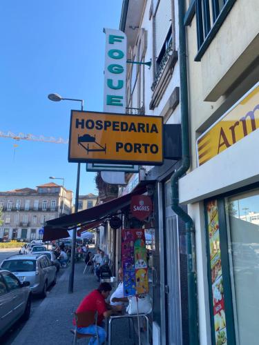 a sign for a hospedaria portico on a street at Hospedaria Porto in Porto
