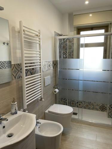 a bathroom with a toilet and a sink and a shower at House on the Sea in Mascali