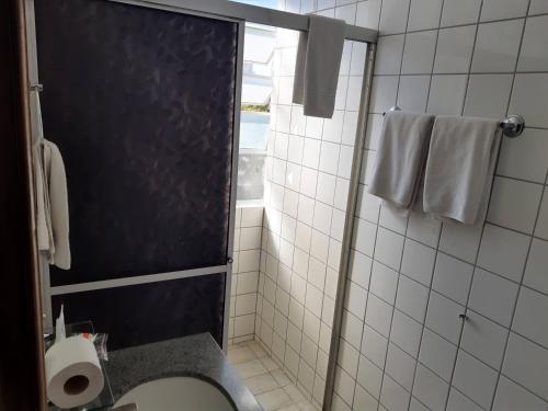 a bathroom with a shower with a toilet and a window at Rede Andrade Guaíra in Curitiba