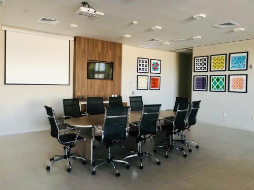 a conference room with a table and chairs at Holiday Inn Express & Suites - Playa del Carmen by IHG in Playa del Carmen