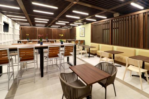 a dining room with tables and chairs at Holiday Inn Express & Suites - Playa del Carmen by IHG in Playa del Carmen