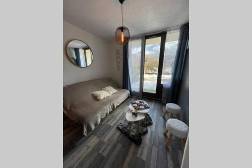 a living room with a bed and a table and chairs at Studio neuf St Lary 10 min à pied in Vielle-Aure