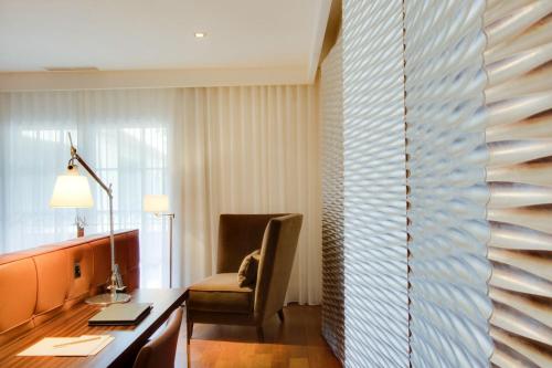 a room with a desk and a chair and a window at Maison Pic in Valence