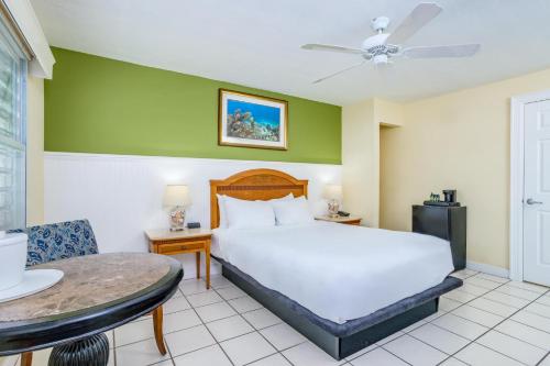 a bedroom with a large bed and a table at Marina Del Mar Resort and Marina in Key Largo