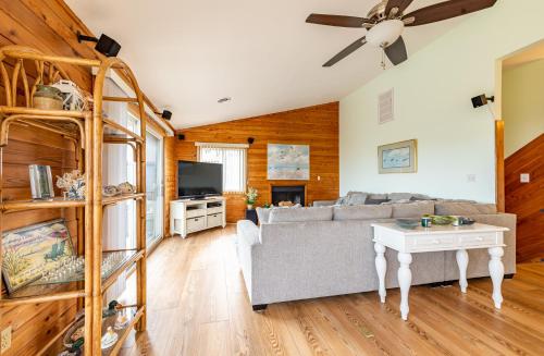 a living room with a couch and a tv at Duck R Way in Duck