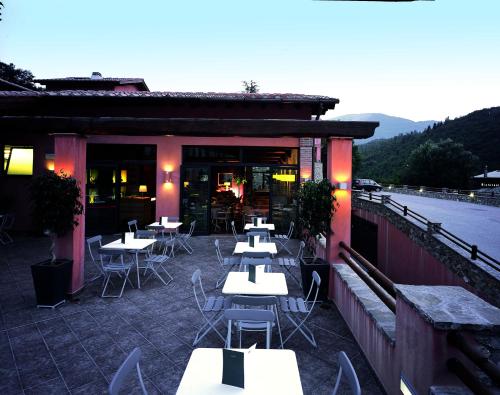 a restaurant with tables and chairs on a patio at Meridiana Country Hotel in Calenzano