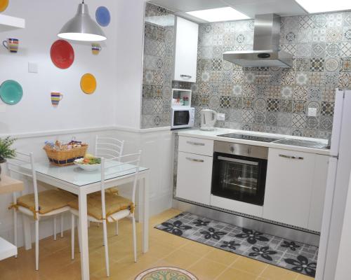 a kitchen with a table and a stove top oven at Private Apartment in Pembroke St Julians in Pembroke 