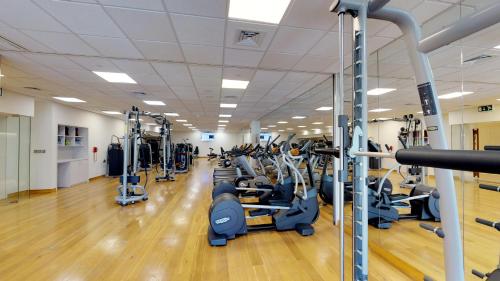 a gym with a lot of treadmills and machines at The Hotel Galleria Jeddah, Curio Collection by Hilton in Jeddah