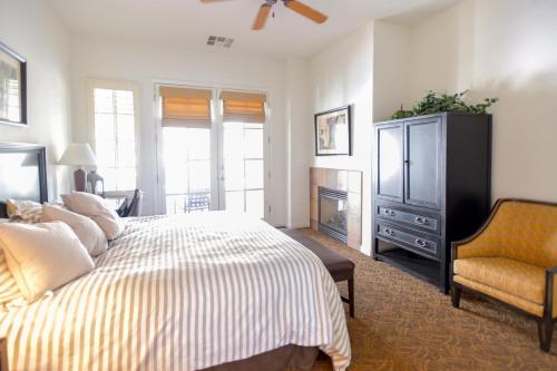 um quarto com uma cama, uma televisão e uma cadeira em Beautiful Casita, La Quinta Legacy Villas Resort em La Quinta