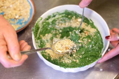 a person holding a spoon and a bowl of pesto at Masseria Sant'Agapito in Lucera