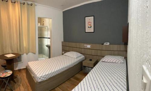Ένα ή περισσότερα κρεβάτια σε δωμάτιο στο Belém Hotel